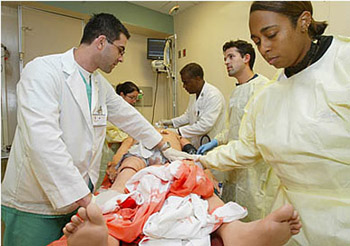 Dr. Marcus Martin, Chair of Emergency Medicine, guides third-year medical students in a simulation