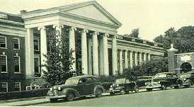 Cars parked infront of the portico entrance to the Medical School